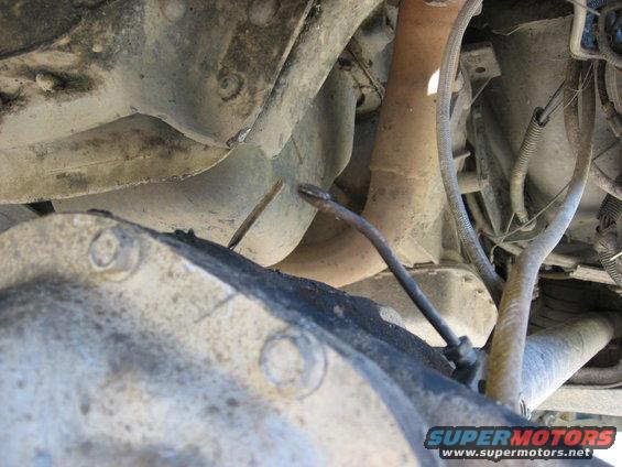 Underside view of vehicle differential and exhaust pipe