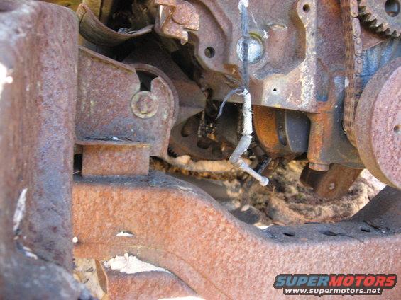 Rusted engine block, timing chain, and frame components