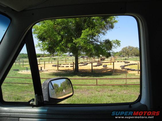 Interior view of a vehicle looking out at a park obstacle course