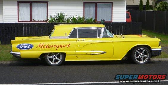 Yellow 1959 Ford Thunderbird with 'Ford Motorsport' text on the side