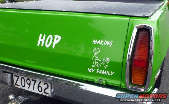 Green pickup truck tailgate with 'HOP' and 'MAKING MY FAMILY' stickers and a license plate Z09762