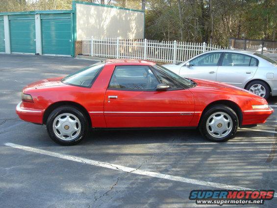 1991 Buick Reatta coupe, side view, parked in lot next to silver sedan