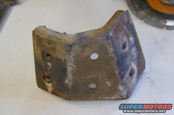 rusted metal bracket with bolt holes