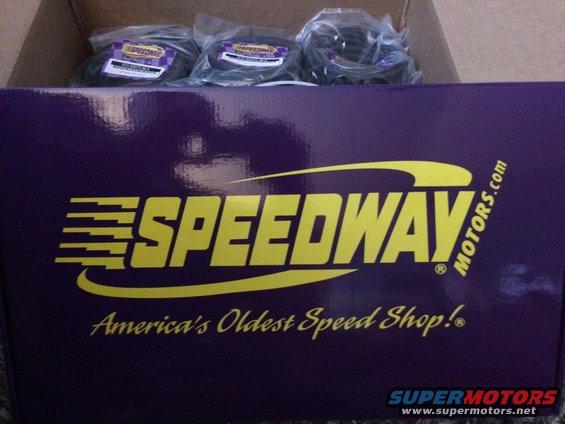 Purple Speedway Motors box with yellow lettering and three bagged parts inside a cardboard box