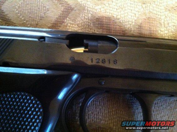 Pistol slide with serial number 12818 and "SUPERMOTORS.NET" watermark