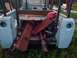 1991 Ford Bronco - The rear of a light blue SUV, filled with scrap metal and a red gas can, sits outdoors.