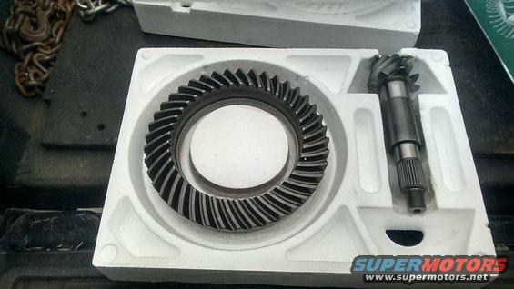 Ring and pinion gears in white foam packaging. Chain in background