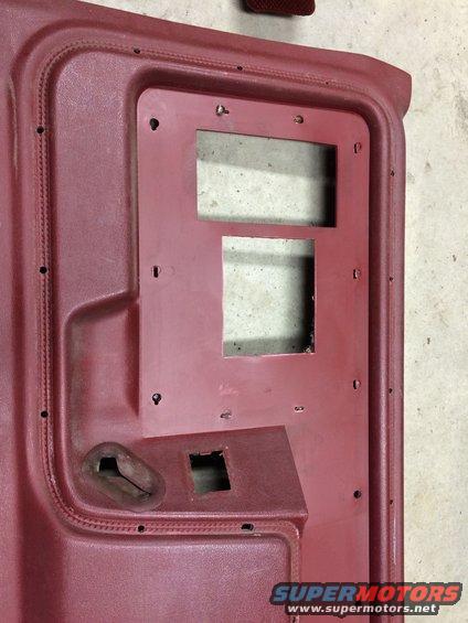 Red interior door panel with cutouts for window and speaker