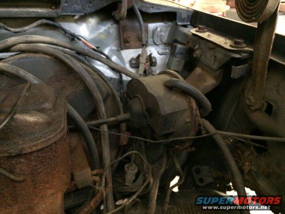 Engine bay with rusted components and wiring harnesses