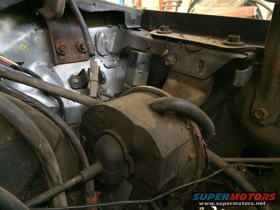 Engine bay components with Ford logo visible