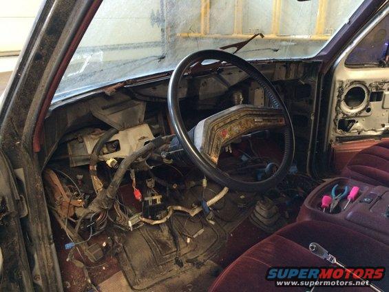 1986 Ford Bronco interior showing disassembled dashboard and center console with tools
