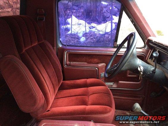 1986 Ford Bronco interior with red velour seats and steering wheel
