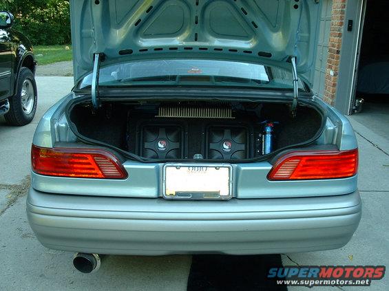opentrunk.jpg subs, one amp, and cap that just looks cool and does nothing really