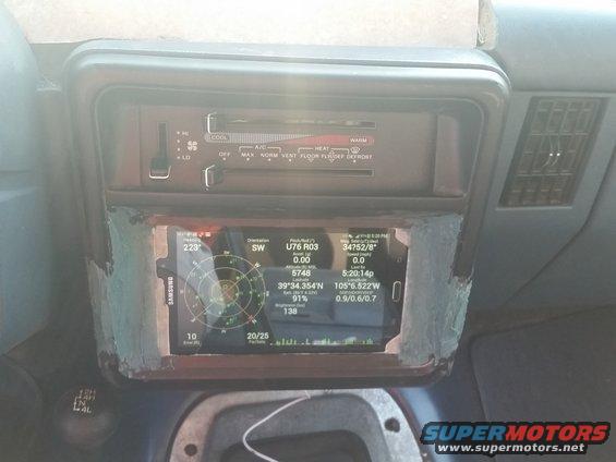 Interior dashboard with aftermarket screen displaying GPS data