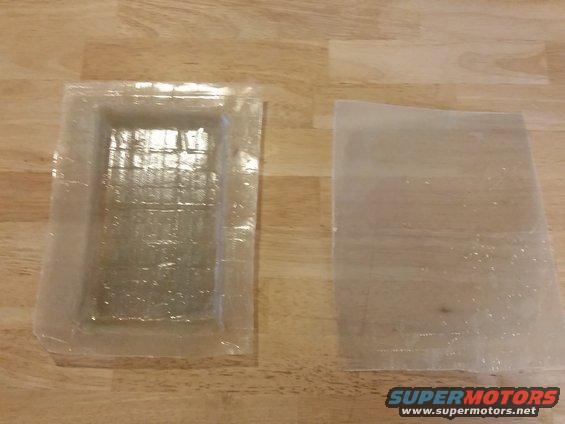 Clear plastic mold and flat sheet on wooden surface
