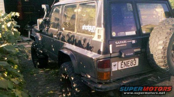 1989 Nissan Patrol Safari Grandroad SUV with spare tire mounted on rear door, license plate ENE83