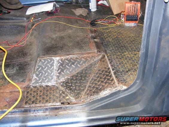 Interior floor of a vehicle with diamond plate patches and wiring