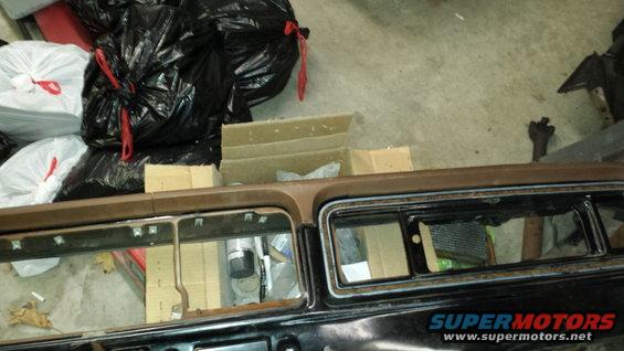 Dashboard and interior parts of a vehicle, with trash bags in the background