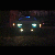 Car front with headlights on, blurry at night