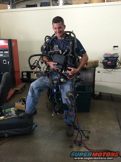 Man wearing a complex vehicle wiring harness