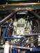 1968 Mercury Cougar - Close-up view of a vehicle's engine bay, focusing on the carburetor and associated components.
