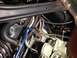 1968 Mercury Cougar - Close-up view of engine components, including a carburetor and various hoses, with directional arrows indicating specific parts.