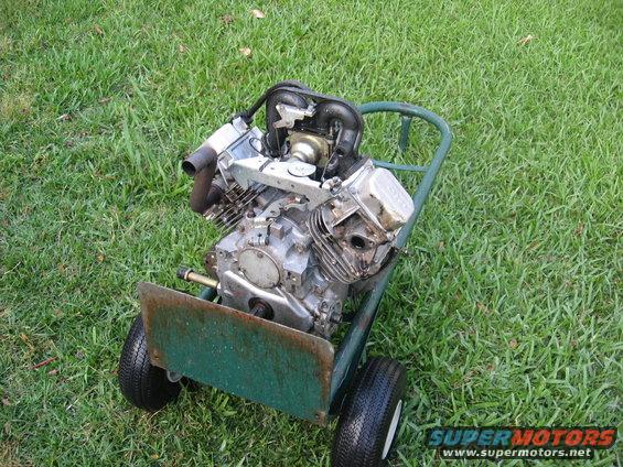 Engine on a green cart with two wheels, viewed from the front