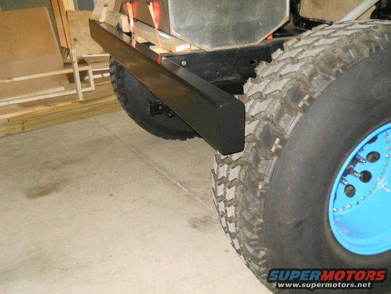 Rear bumper and large off-road tire with bright blue wheel