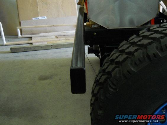 Close-up of a vehicle's frame rail and large off-road tire