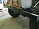 1992 Ford Bronco - Close-up of a vehicle's rear bumper and tire, with a cargo box secured above.