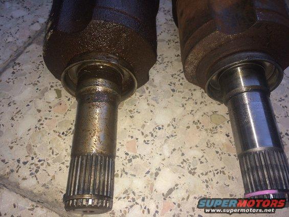Two CV axles with splined ends, one looks newer than the other