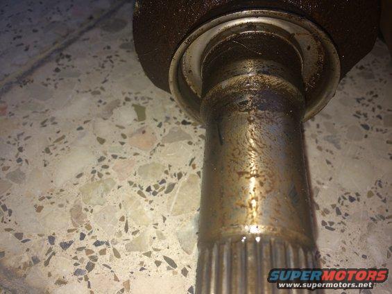 Close-up of a CV shaft and seal with visible wear marks