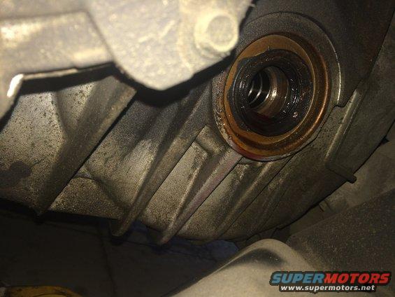 Close-up of a worn drivetrain seal with some fluid residue