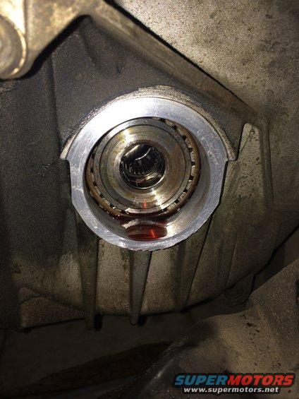 CV shaft seal housing with bearing and fluid residue