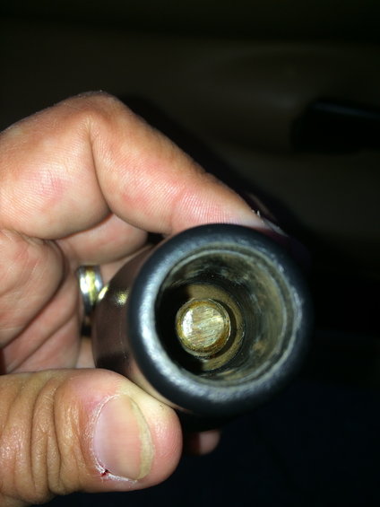 Close-up of the inside of a shifter knob with a metal shaft visible