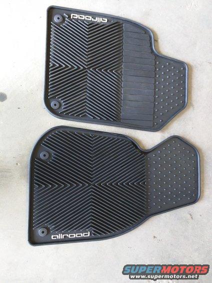 Two black rubber allroad floor mats with textured patterns and circular fasteners