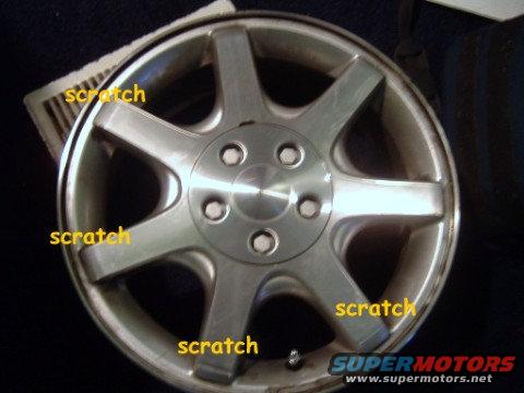 Scratched alloy wheel with SuperMotors.net logo