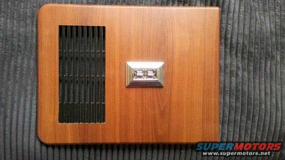 Wood-grain door trim panel with black vent and chrome window crank