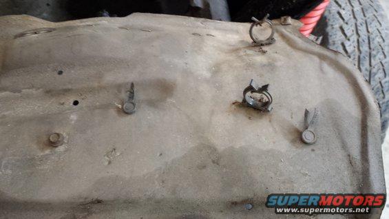 Fuel tank with hose clamps and visible Supermotors.net logo