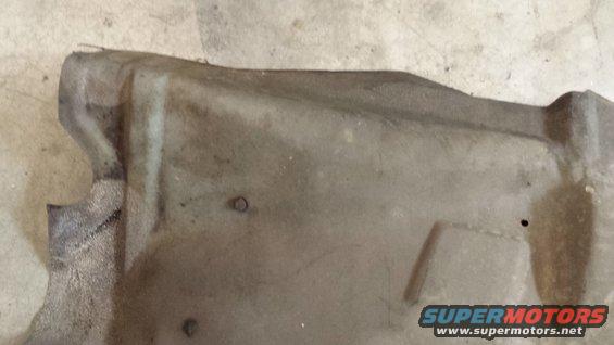 Underside shield with mounting holes and textured surface