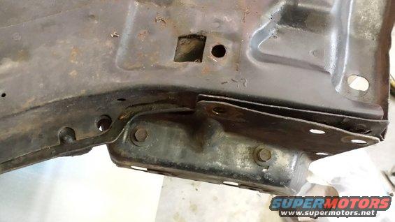 Close-up of rusty metal frame with bolts and brackets