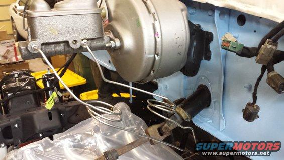 Brake master cylinder and booster assembly in a vehicle engine bay