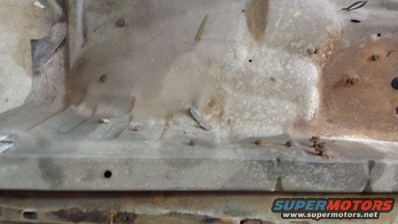 Vehicle floor pan with rust and visible rivets