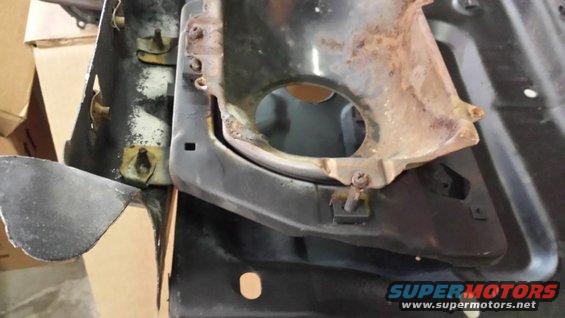 Rusted metal part with circular opening and SuperMotors.net logo