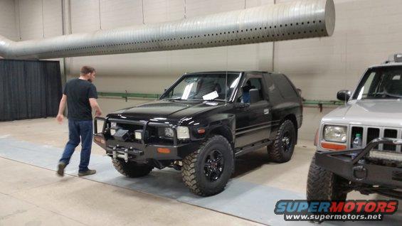 Black SUV with aftermarket bumper and winch, 3/4 front view