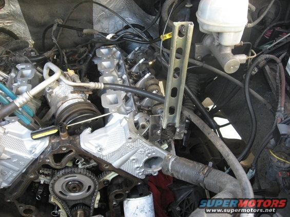 Close-up of a vehicle's engine bay with various parts and hoses visible