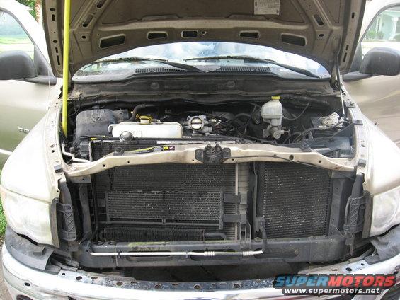 Front view of a 2004 Dodge Ram 1500 with the hood open, showing the engine bay and radiator