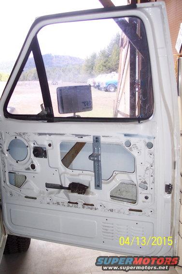 White truck door interior with visible window mechanism and date stamp 04/13/2015