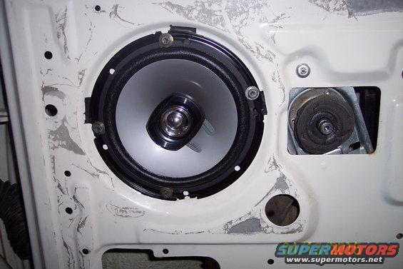 Door speaker and window regulator mechanism inside a white door panel