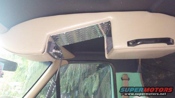 Interior shot of a custom overhead console with diamond plate accents and a CB radio mount